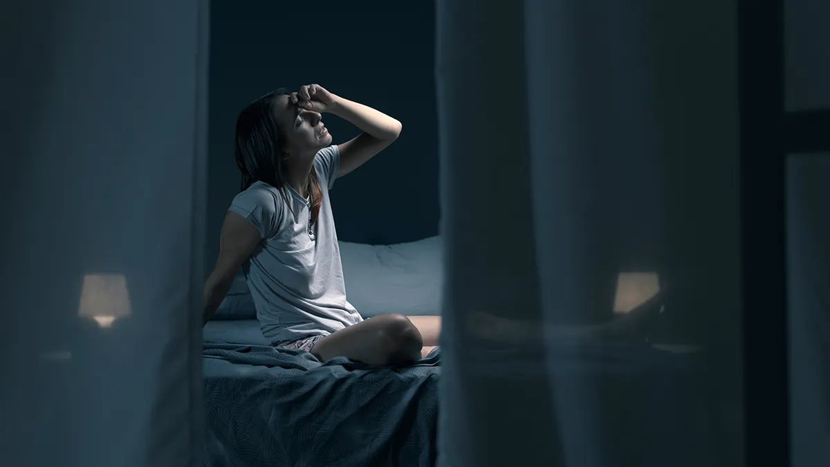 We're seeing a woman who can't sleep through a slightly opened curtain on her bedroom window